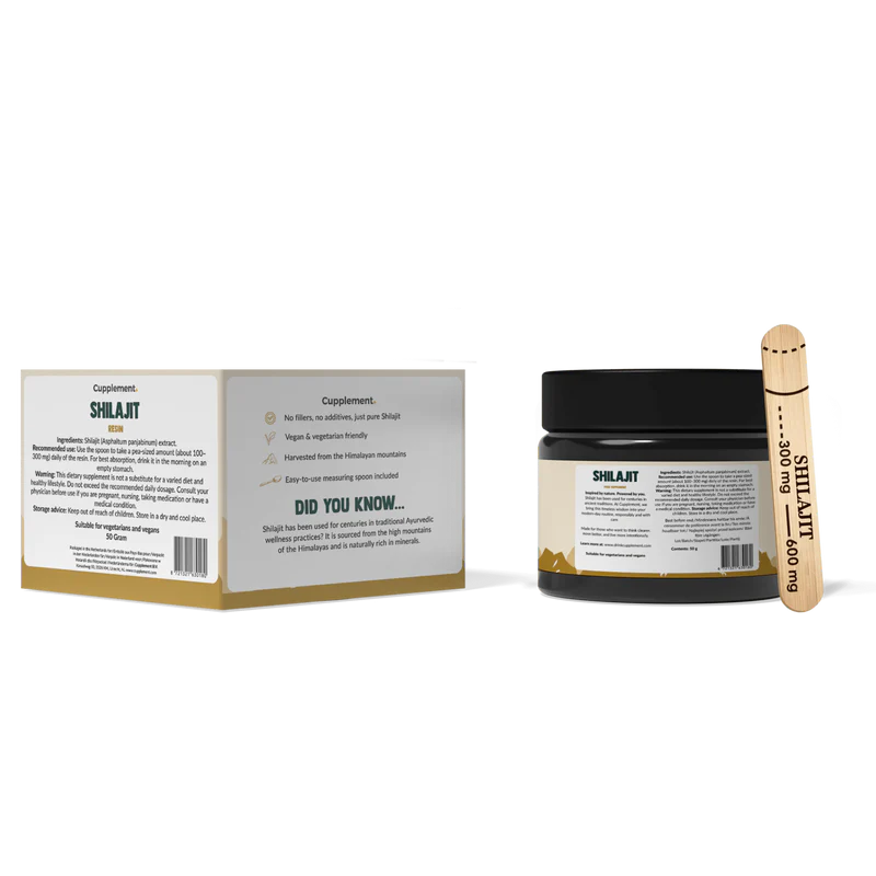 Shilajit supplement jar with packaging and wooden scoop on a white background